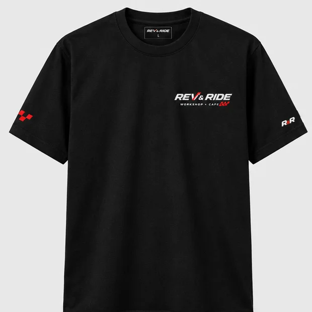 Front of the black Rev & Ride t-shirt: logo on the left chest, red checker flag and R&R on the sleeves
