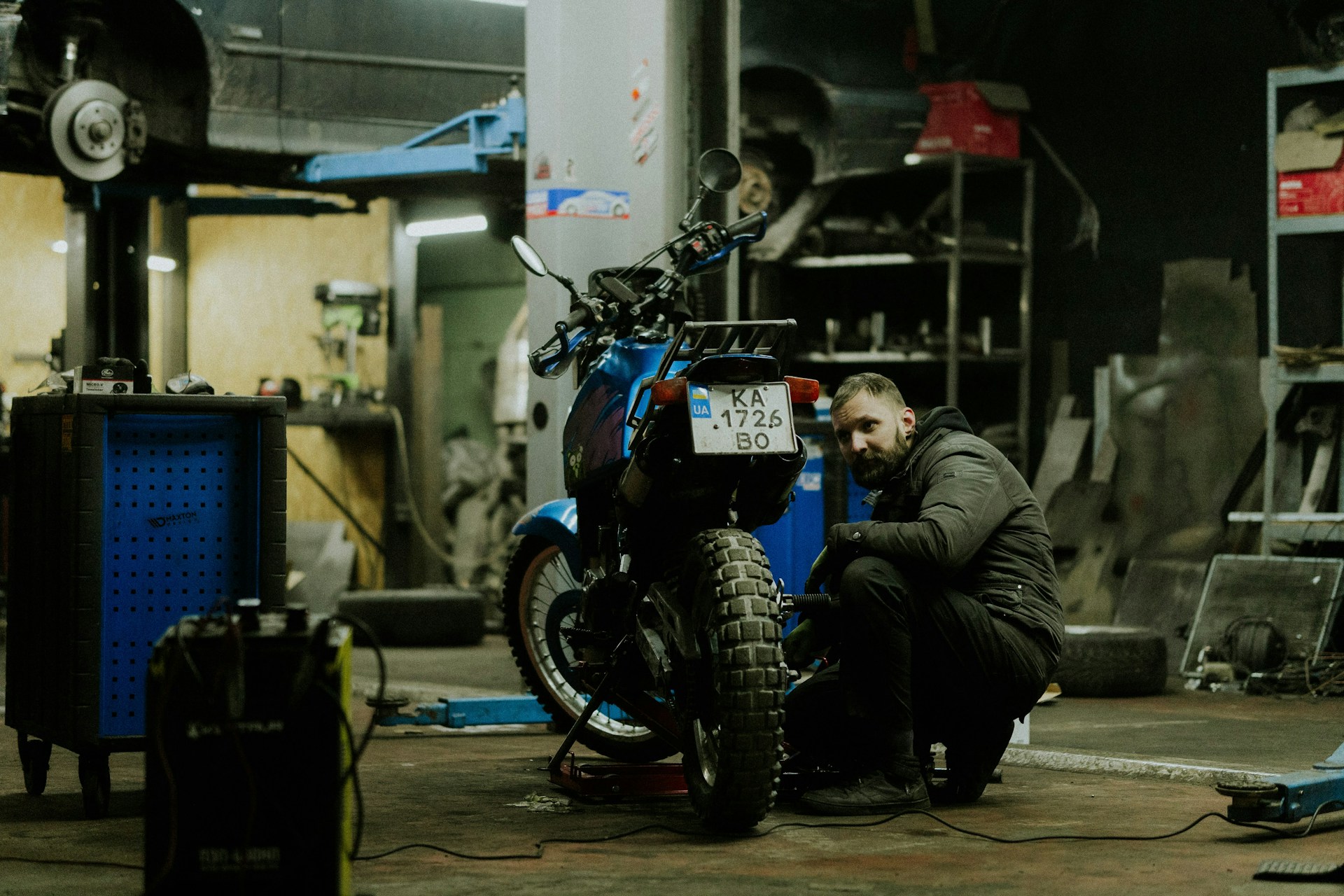Mechanic working on motorcycle in garage — Rev and Ride workshop